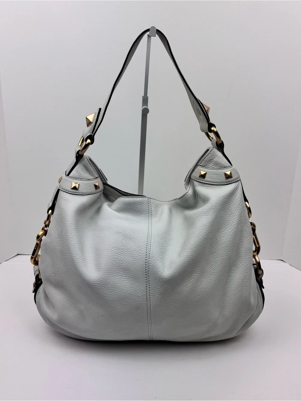 B. Makowsky Leather Ivory Hobo handbag. Gold-tone stud accent hardware.
